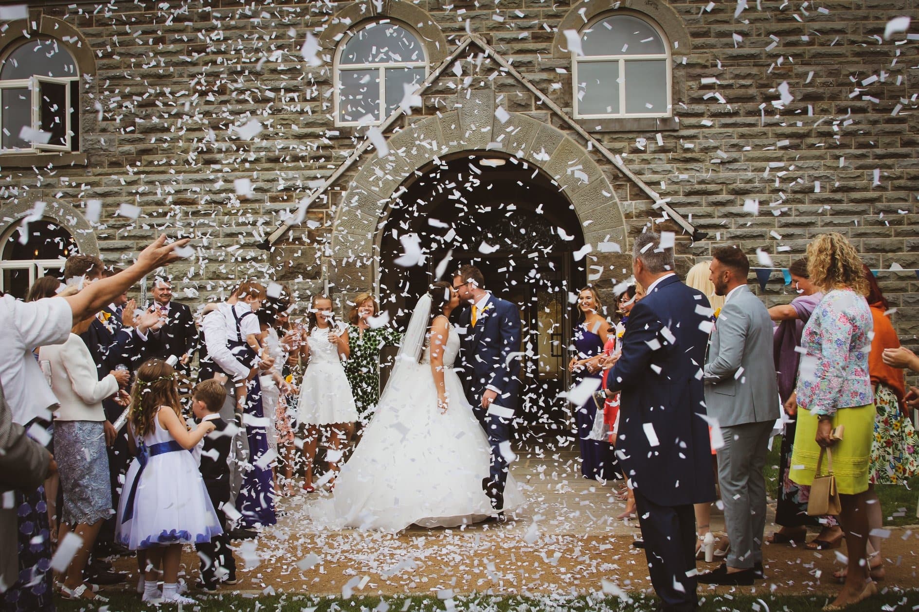 A bride and groom walking through confetti at Darwin Lake